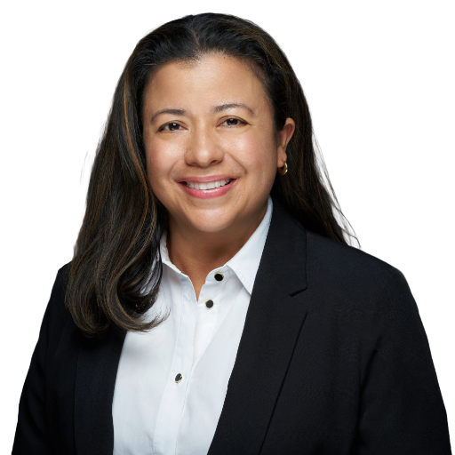 Professional headshot of a smiling person in a black blazer and white shirt on a white background