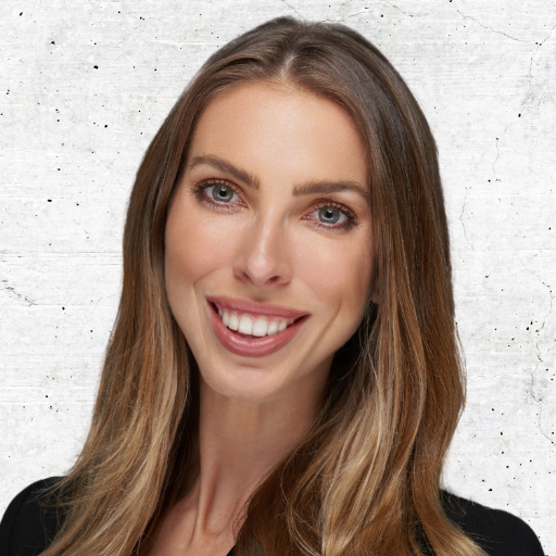 Portrait of a smiling woman with long brown hair against a light gray background