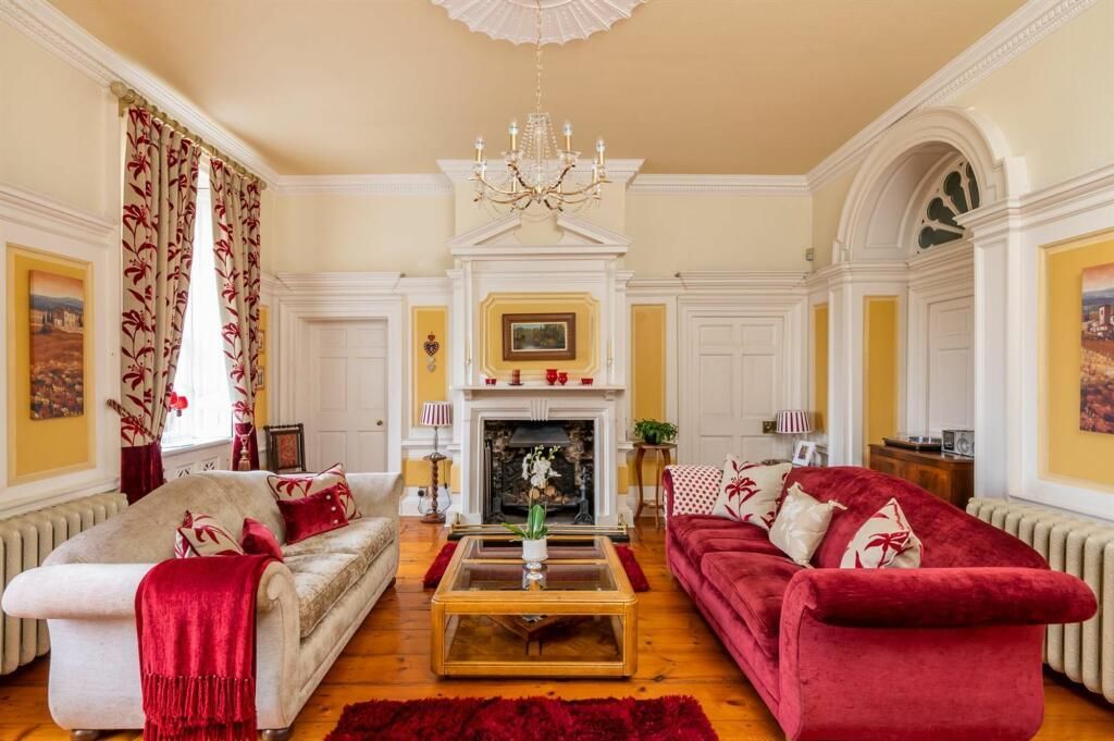 Decorated period sitting room – rich, timeless yellow tones applied with precision to highlight original mouldings