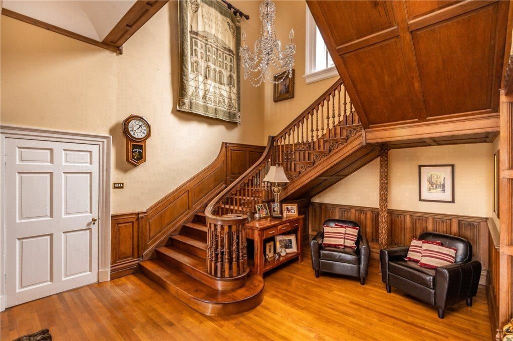 Grand heritage staircase – deep-toned timber balustrade and panelling restored with precision for enduring elegance