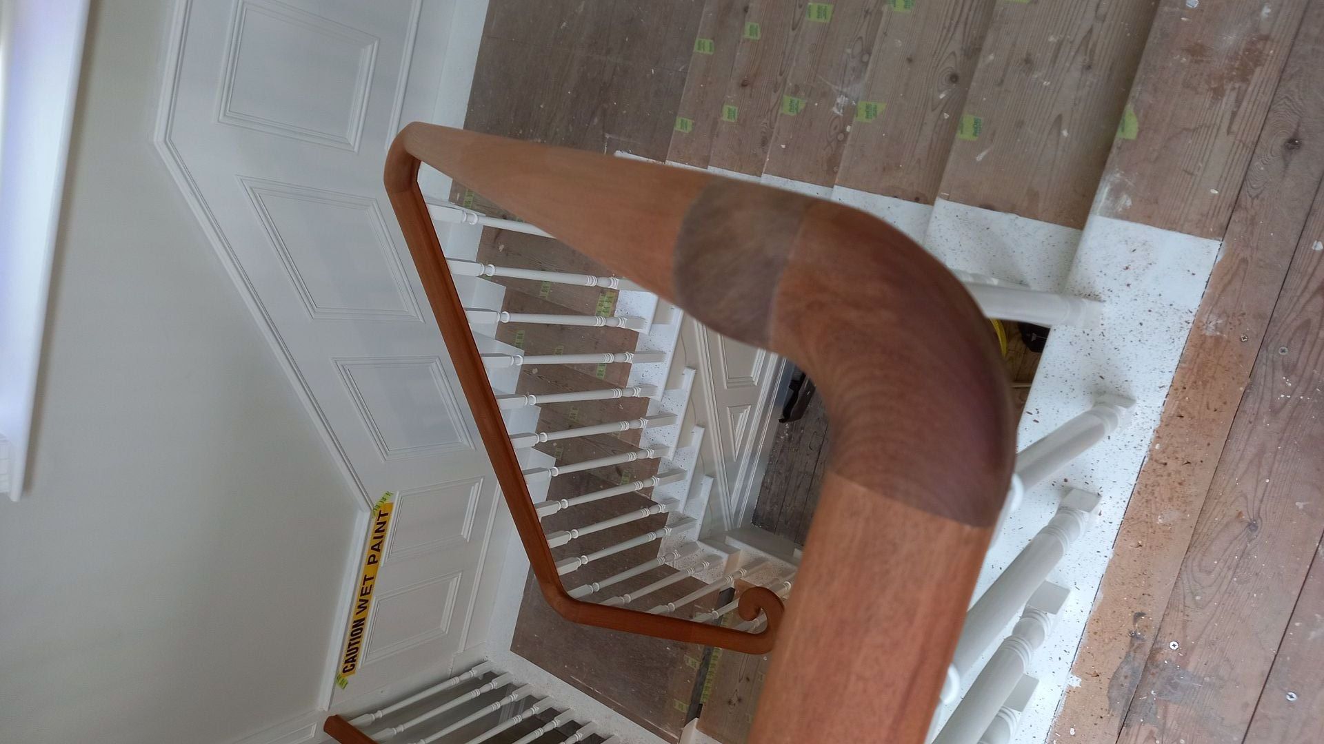 Meticulous handrail preparation – delicate curves and timber gently protected before staining begins