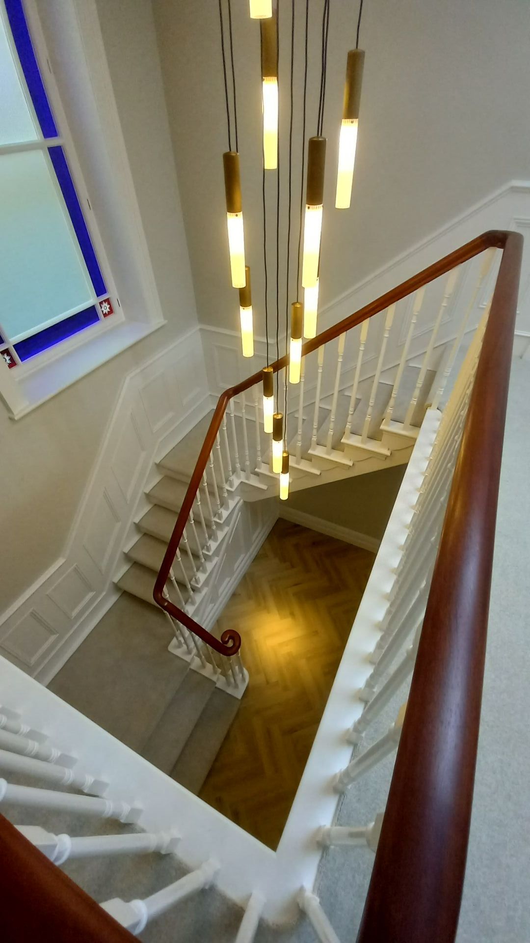 Heritage staircase in careful transformation – illuminated handrail and bespoke wood panelling