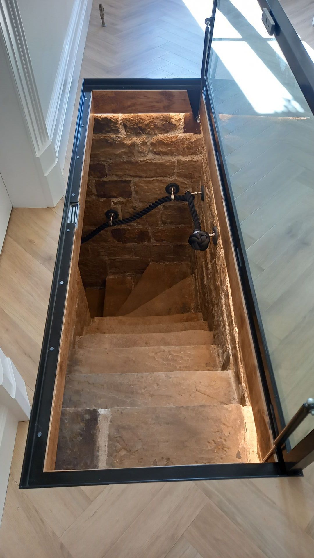 Restoration of historic stone cellar staircase – original rugged stone steps and walls gently cleaned and respected