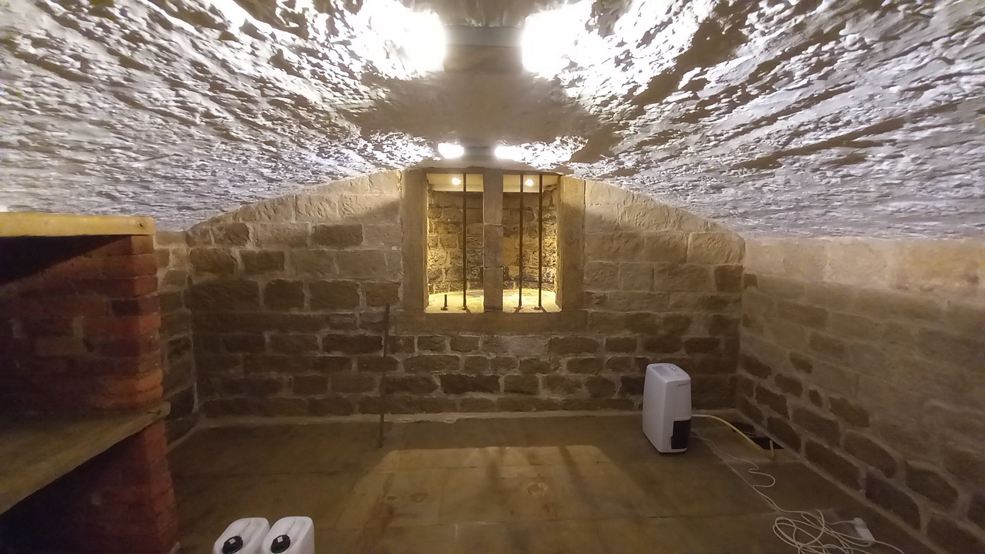 Deep stone walls, arched features and freshly painted white vaulted ceiling, restored for enduring elegance