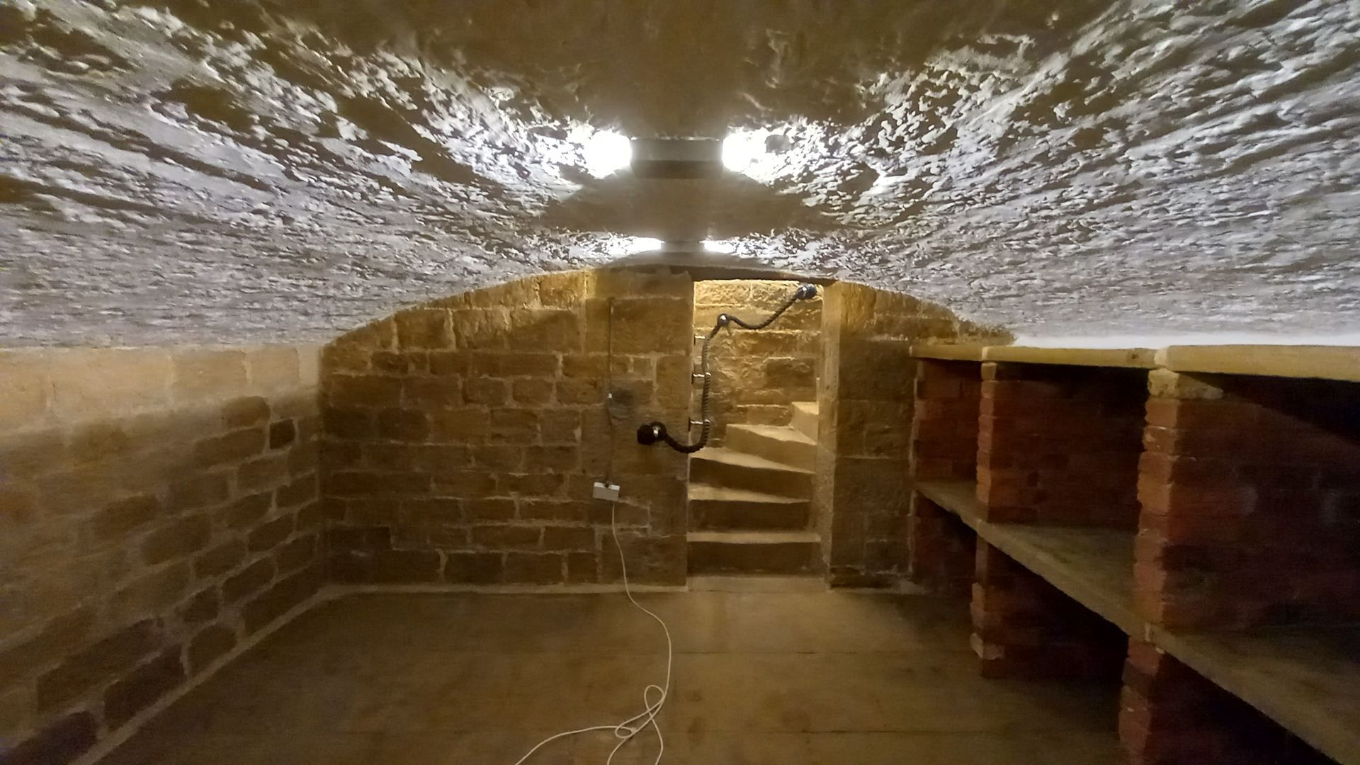 Historic arched stonework cleaned and ceiling finished in crisp white to enhance light and timeless character