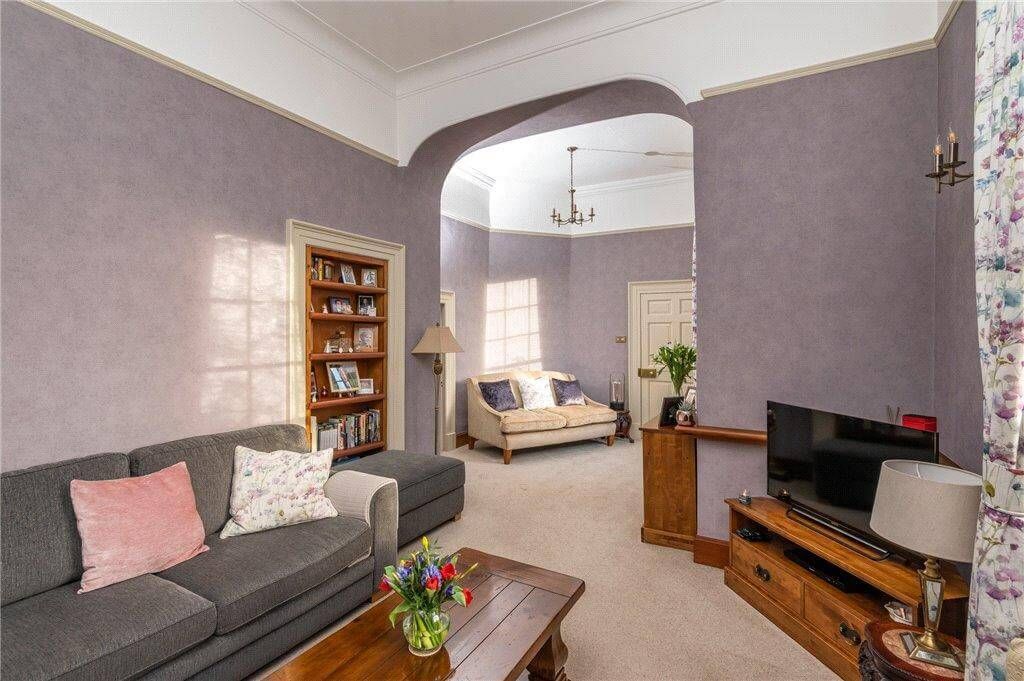Meticulous heritage living space restoration – arched openings and soft tones enhanced with precise craftsmanship