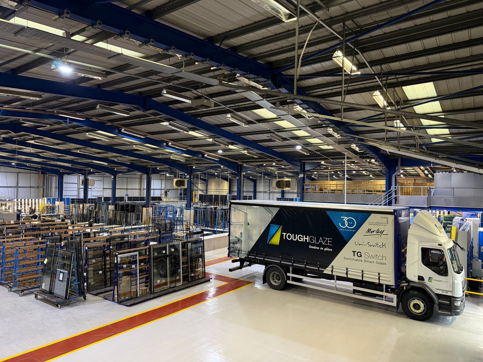 Durable epoxy floor coatings in industrial unit – coatings refreshed around racking and loading bay for operational safety