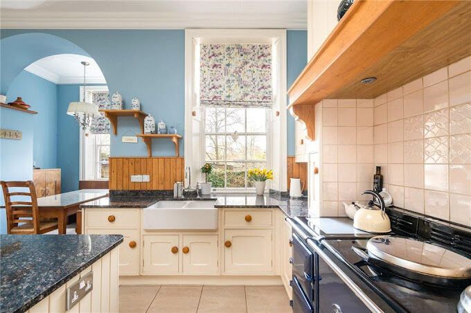 Restored period kitchen in soft blue – breathable paint preserves original features for timeless family elegance