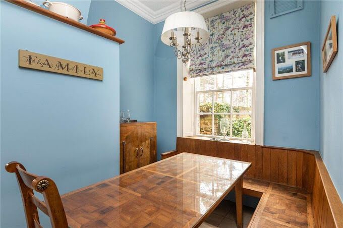 Meticulous kitchen refresh – blue walls and cream cabinetry finished with precision for cherished daily living