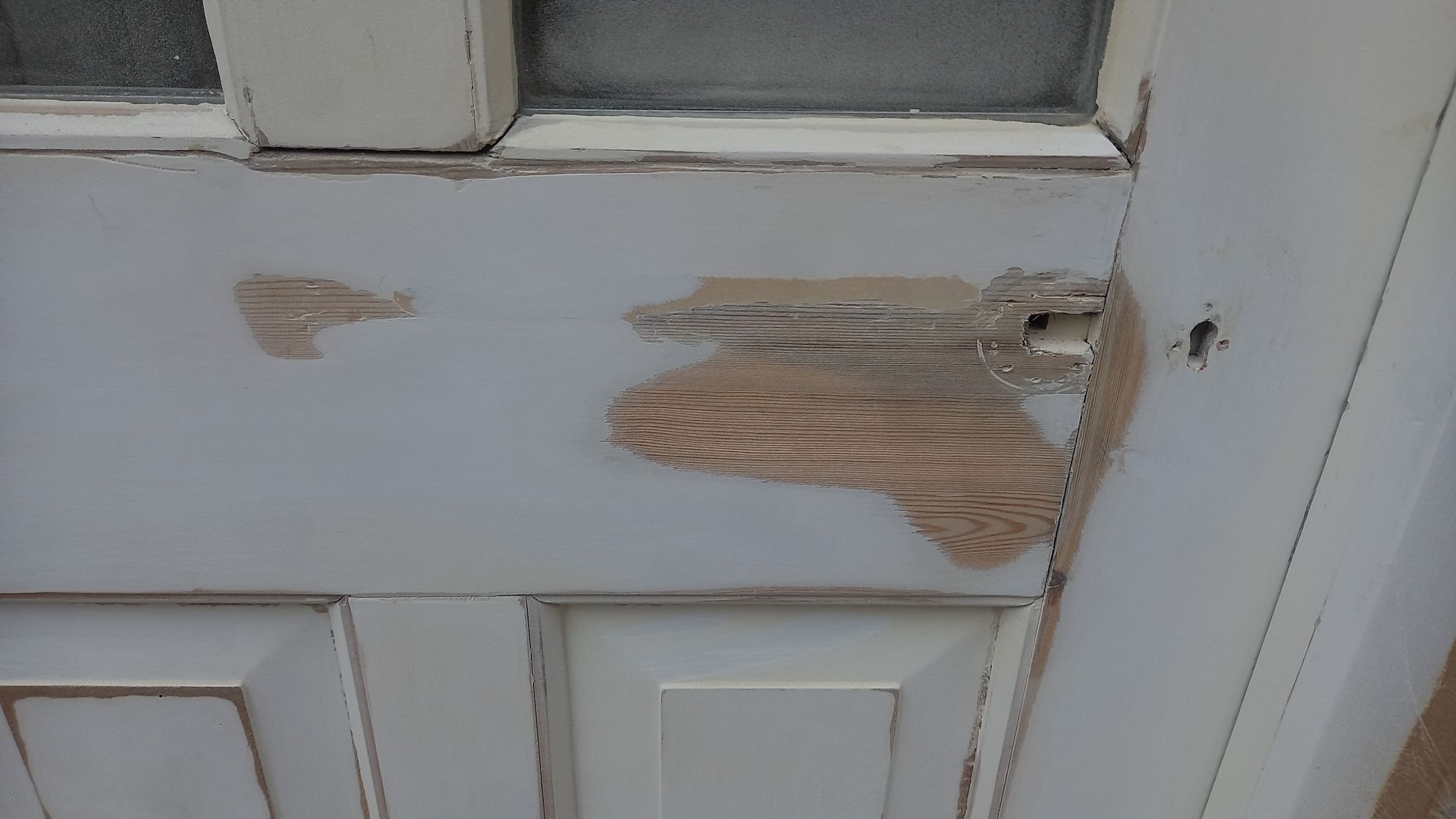 Timber repair on period door panel – damaged wood carefully removed and prepped for sympathetic filling