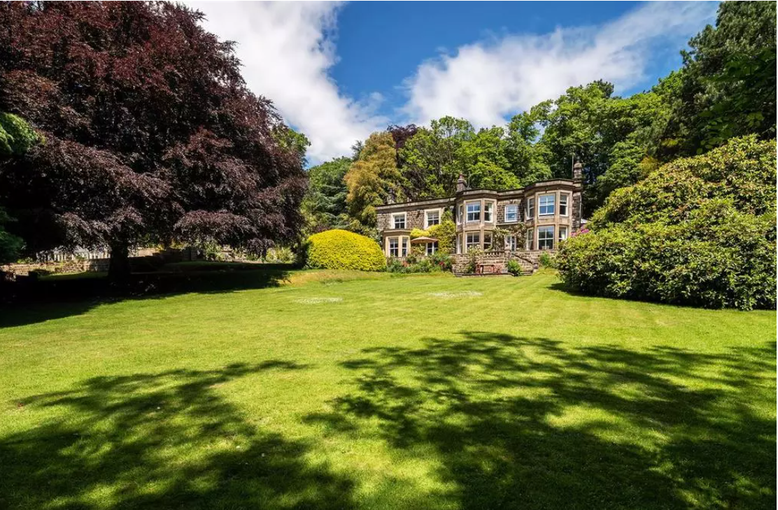 Exterior view of a high-end stone period property, showcasing professional exterior finishes and heritage architecture