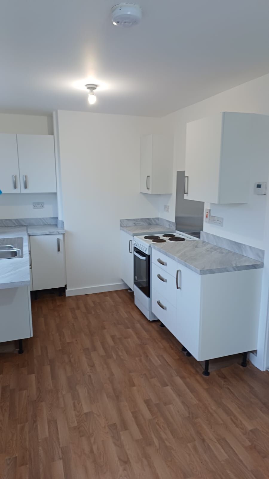 Quick-turnaround social housing kitchen – breathable coatings applied to walls and joinery during void period