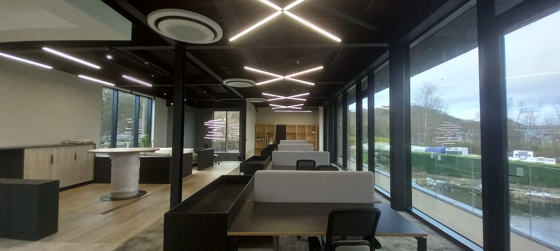 Commercial office interior – sleek black beams and LED lighting enhanced with precise neutral coatings for a modern workspace