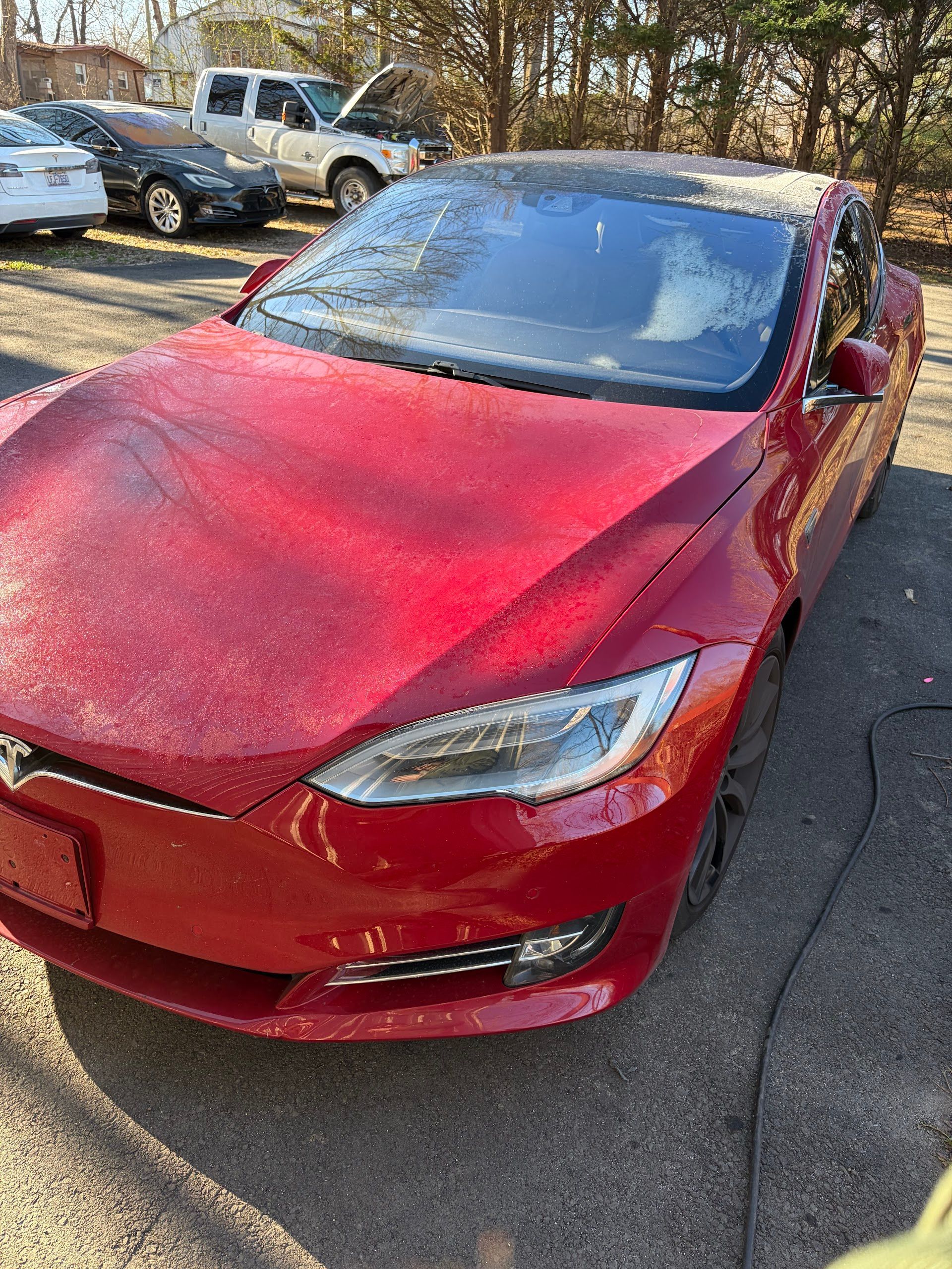 Red Tesla Sedan Front Angle View Outside | Pulse Automotive