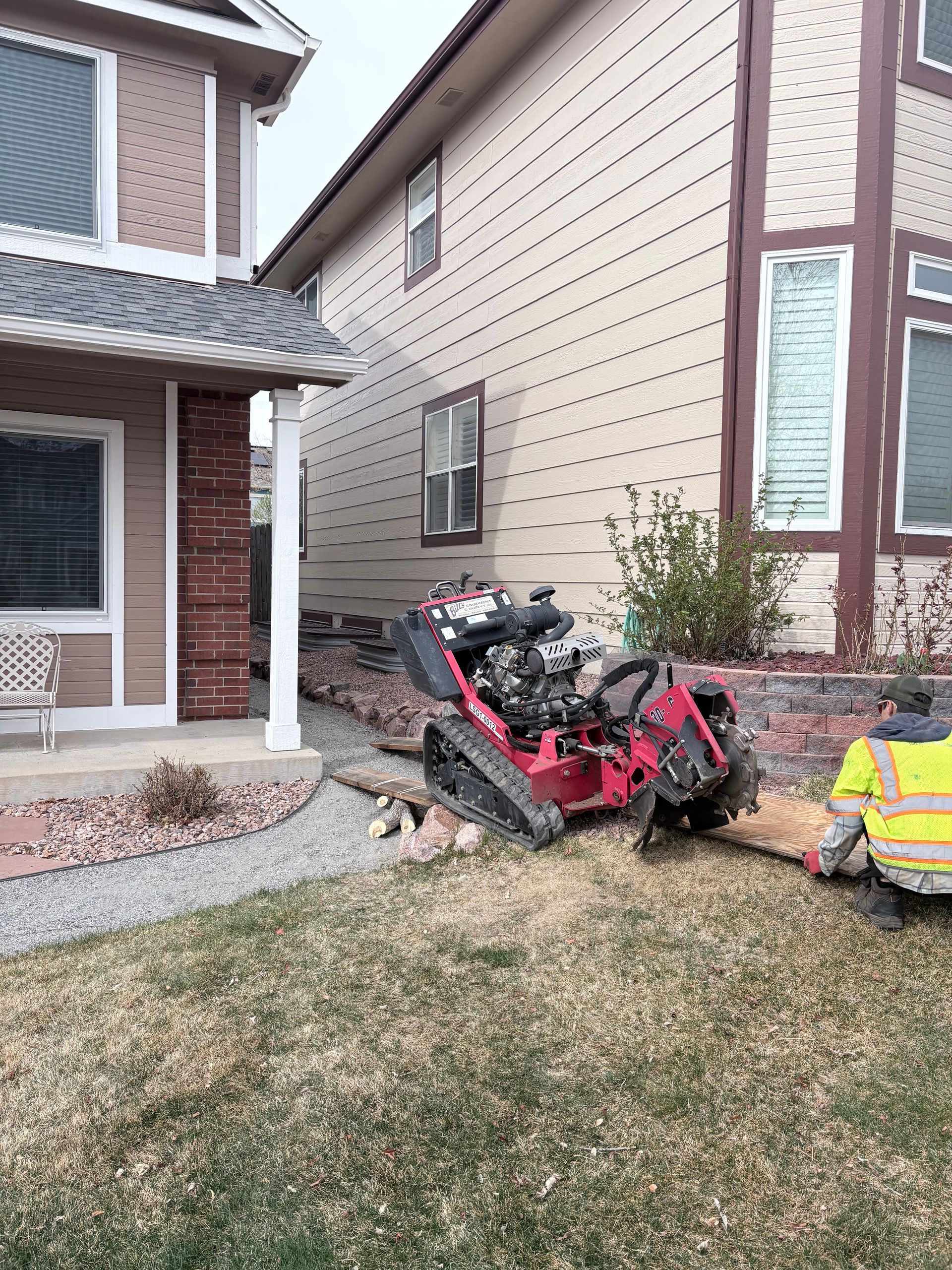 Crashed red ATV beside a suburban house, with a yellow vehicle partially visible on the right.