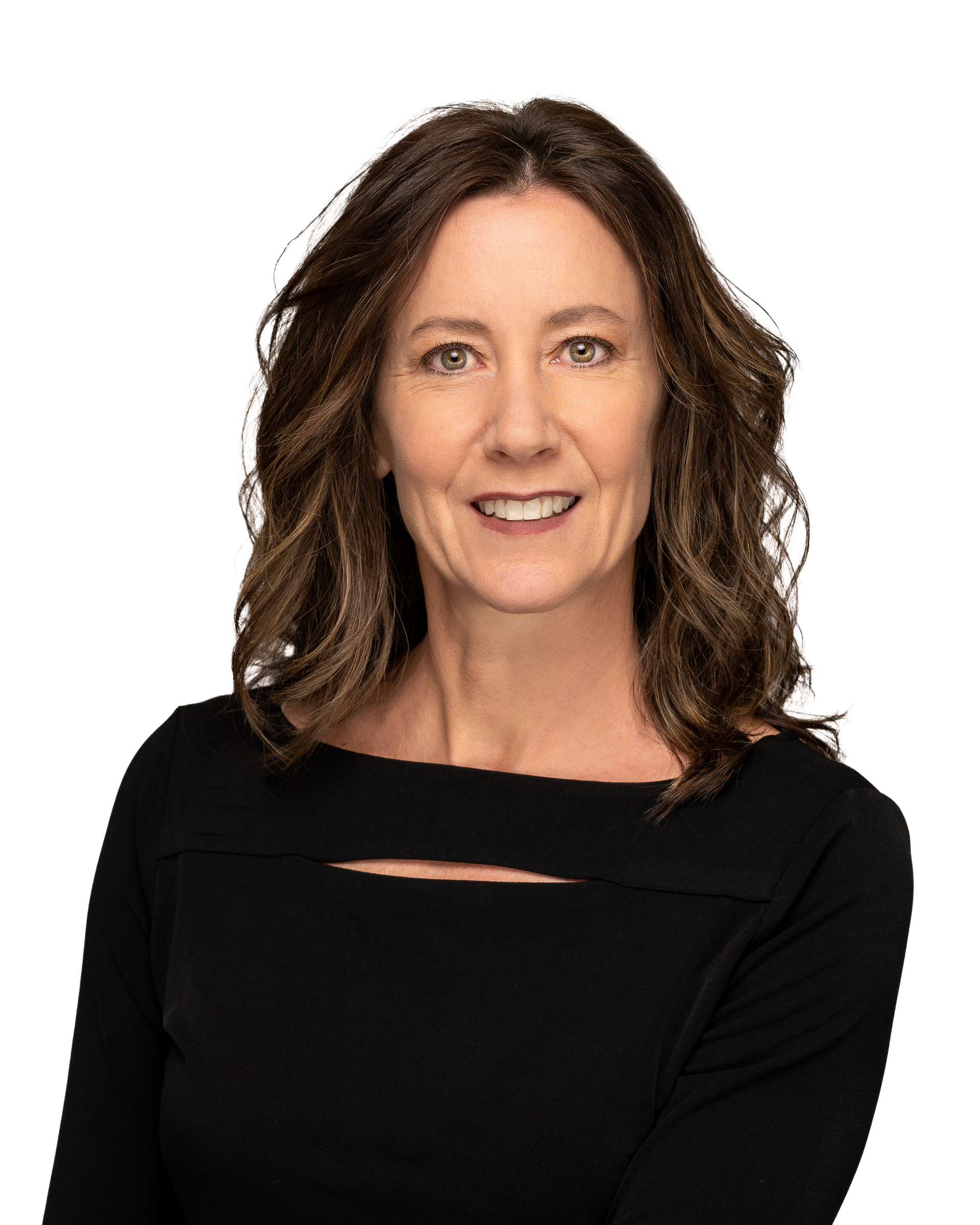 A woman in a black dress is smiling for the camera.