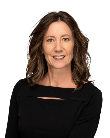 A woman in a black dress is smiling for the camera.