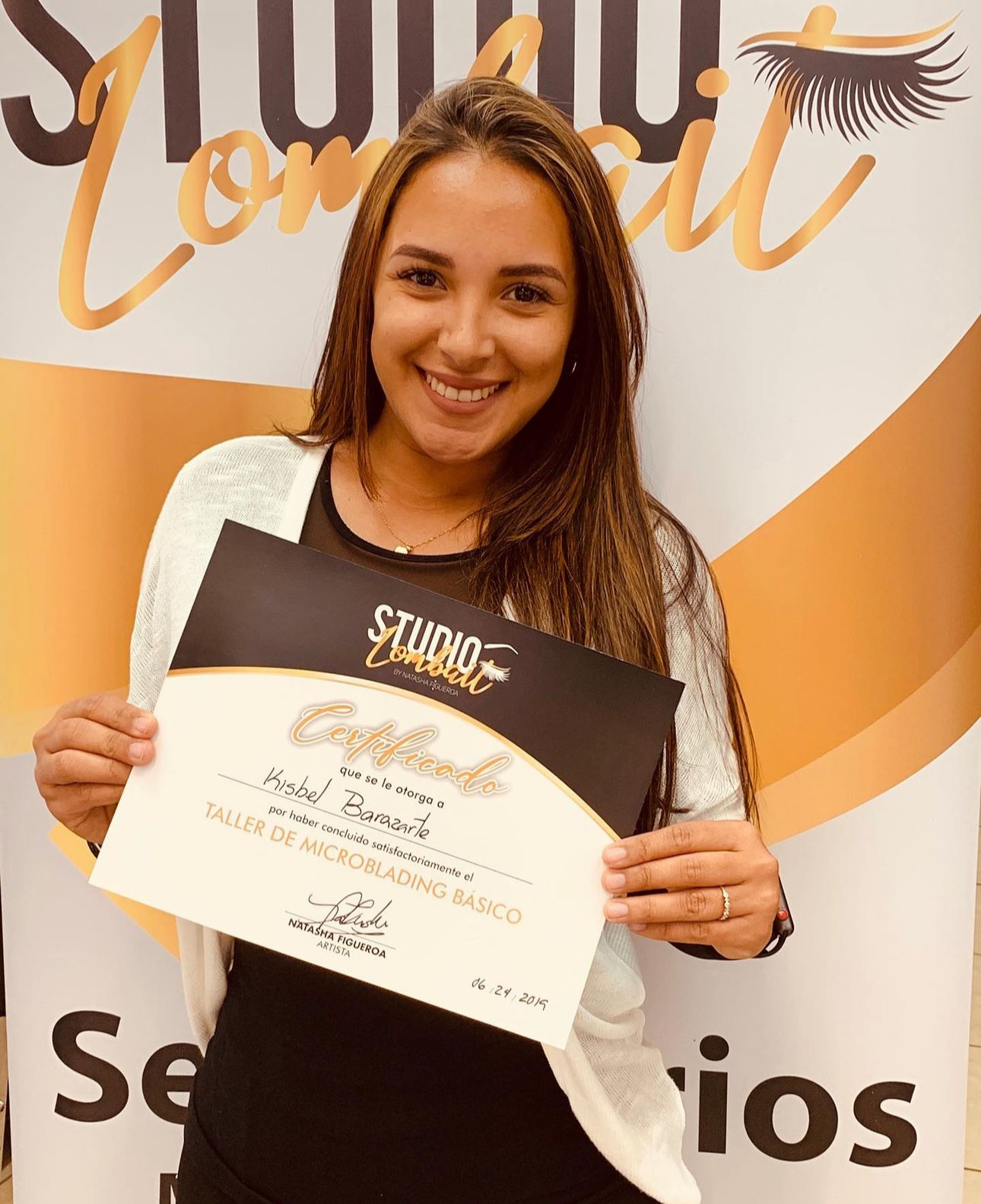A woman holding a certificate that says studio on it