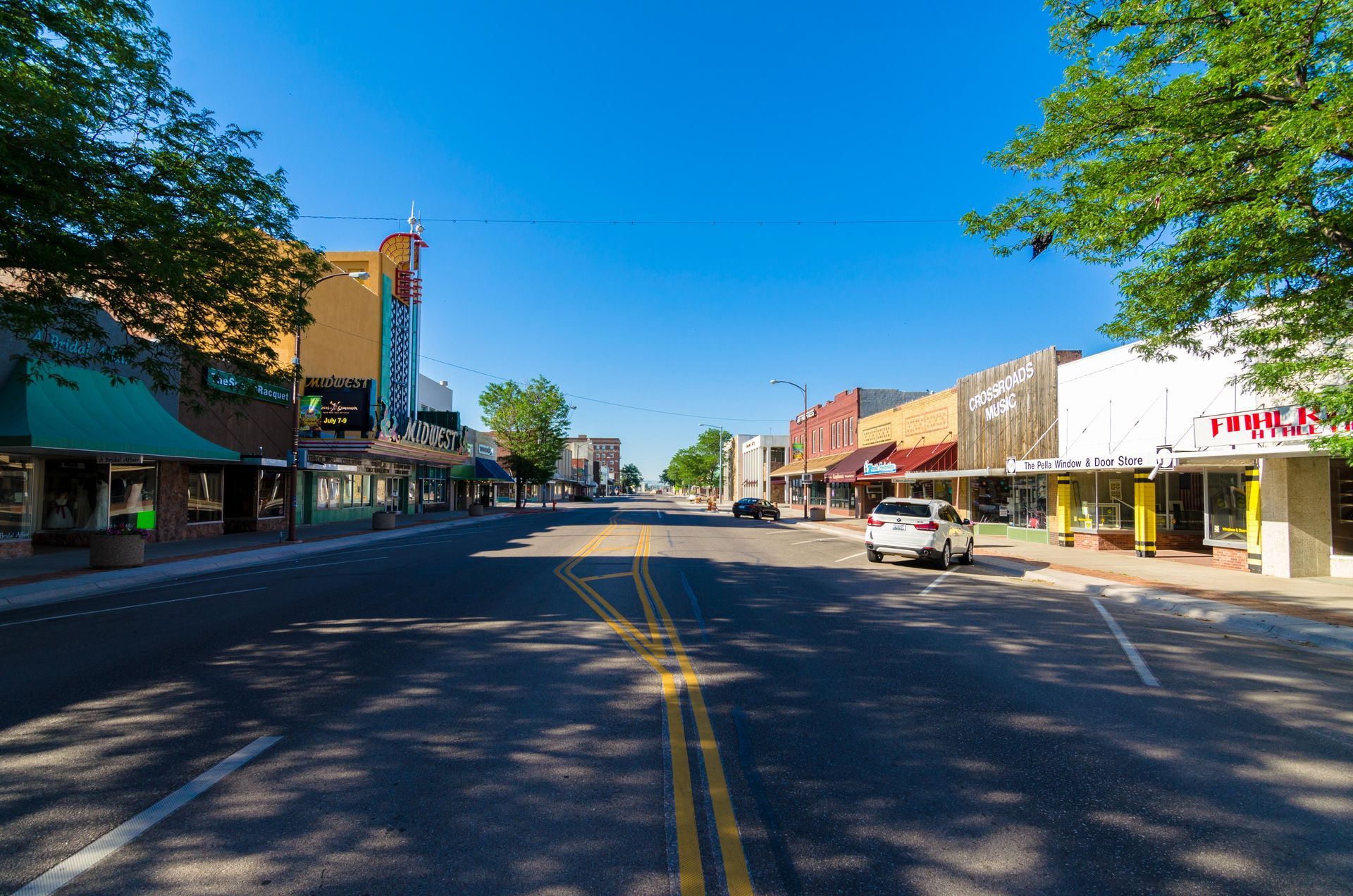Weathercraft - Scottsbluff, Nebraska's Trusted Roofing Contractor A car is driving down a street in a small town.