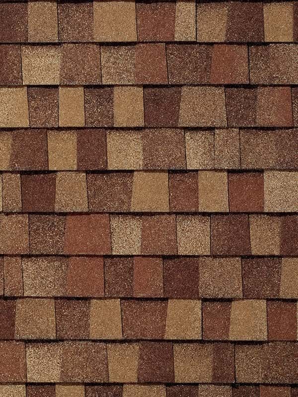 A close up of a roof with brown and tan tiles