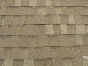 Dimensional or Heritage style A close up of a roof with shingles on it.