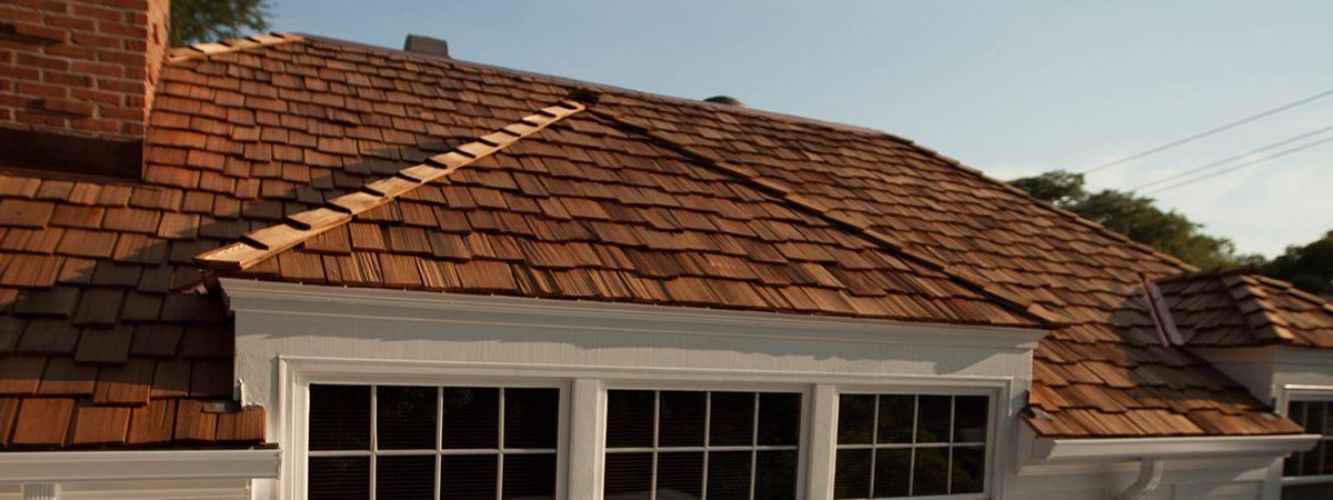 Wood Shakes A house with a wooden roof and a chimney.