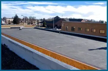 The roof of a building with a blue sky in the background