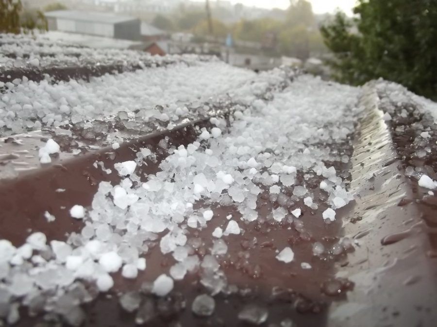 Wood Shingles There is a lot of hail on the roof of a building.