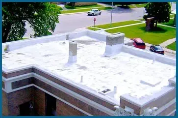 A white roof with a chimney on top of a building