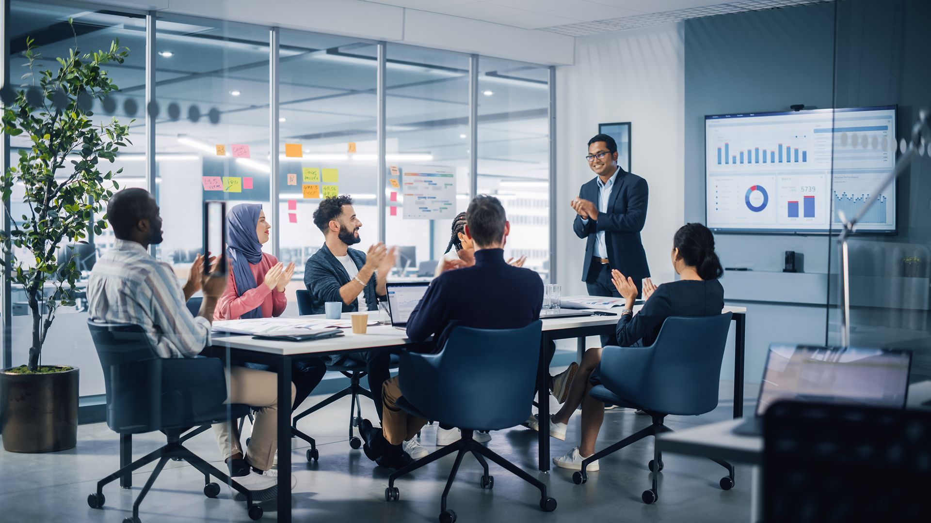 A group of business people are putting their hands together.