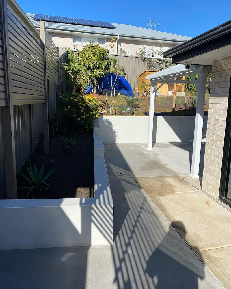 Pathway with Concrete Walls, Leading to A Small Sheltered Area with A Play — Millers Masonry In Port Macquarie, NSW