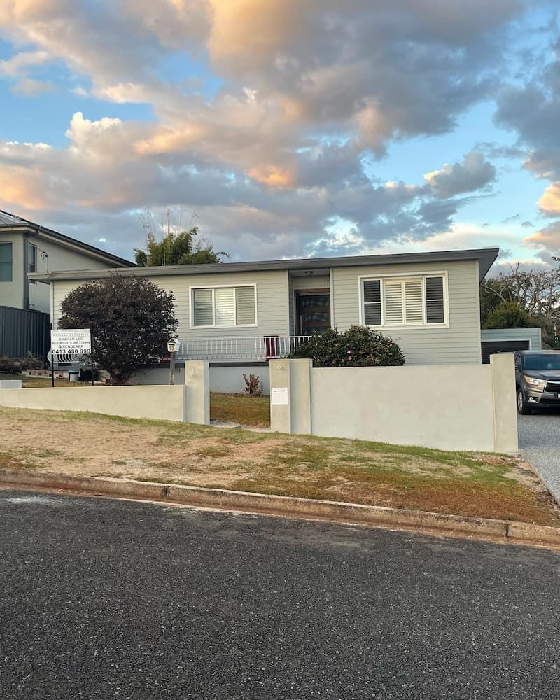 A House With A Car Parked In Front Of It — Millers Masonry In Port Macquarie, NSW