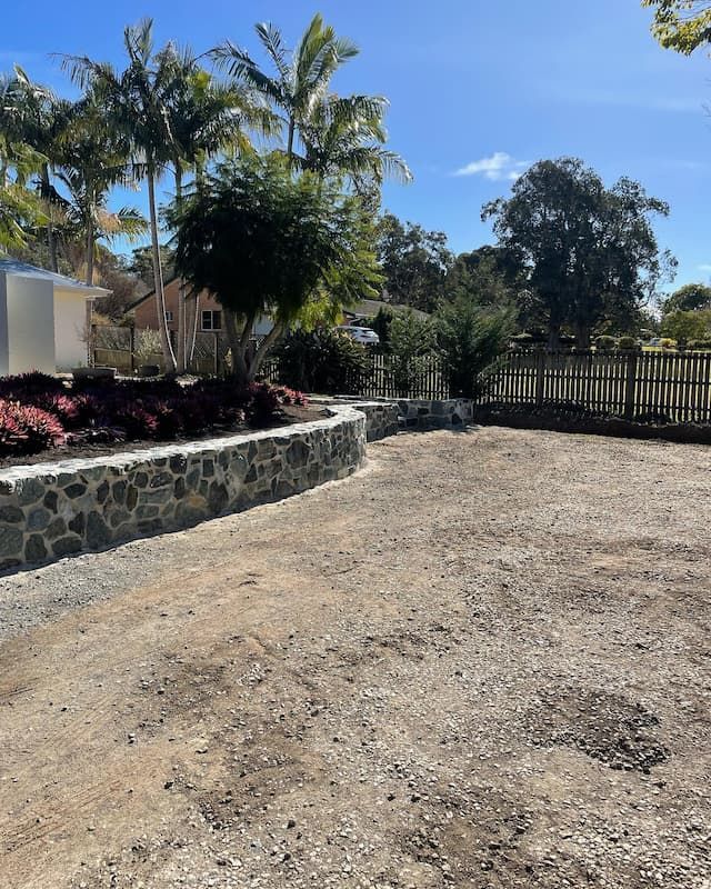 Modern building entrance with ramps, black metal fence, and concrete walkway under a clear sky — Millers Masonry In Port Macquarie, NSW