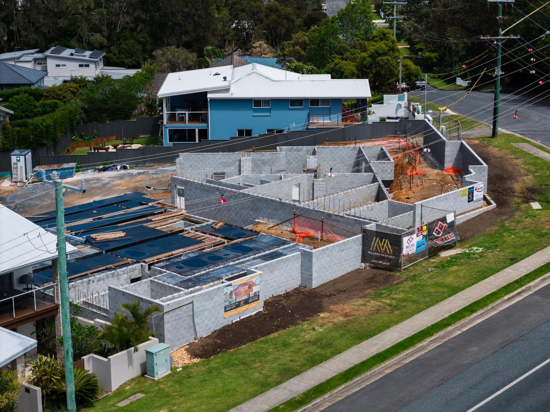 Construction Site with Gray Concrete Walls, Surrounded by A Fence — Millers Masonry In Port Macquarie, NSW