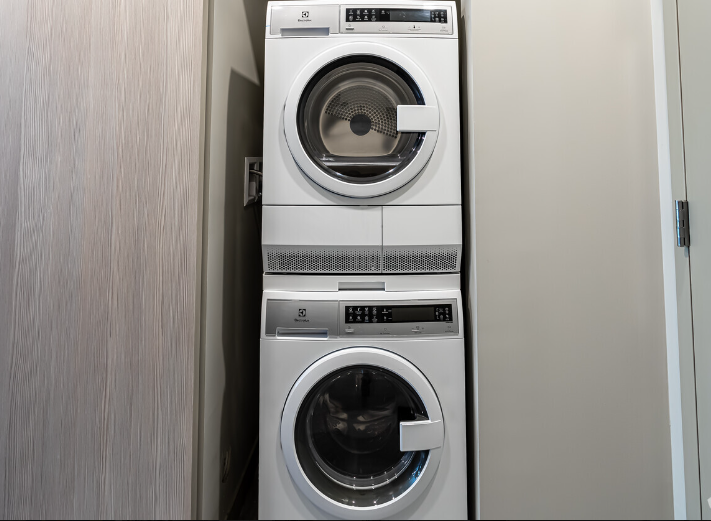 A washer and dryer are stacked on top of each other in a laundry room.