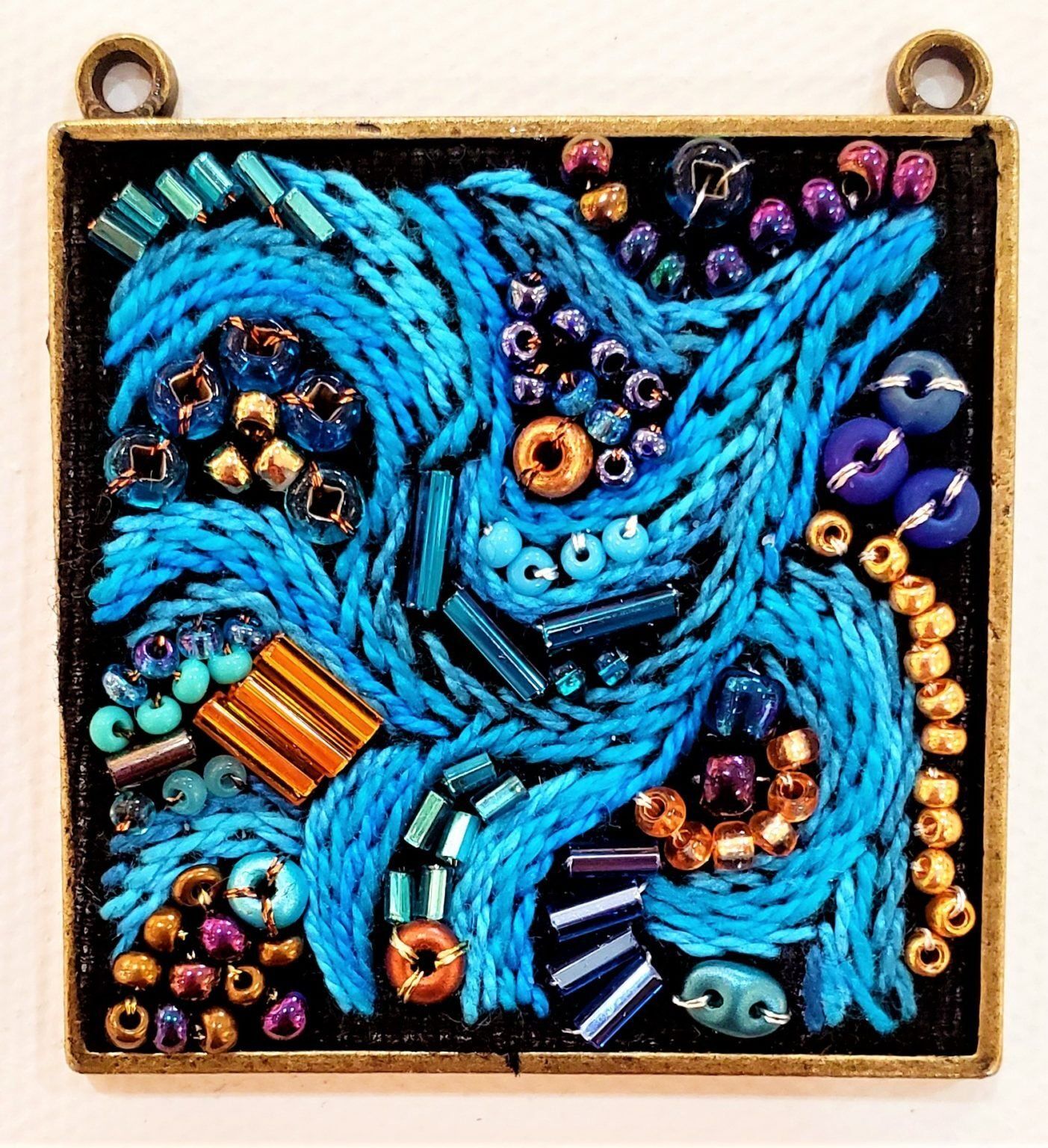 A painting of blue beads on a black background