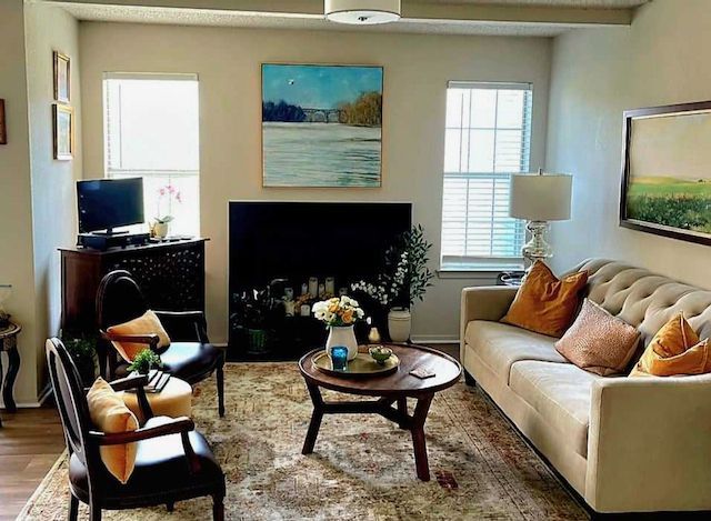 A living room with a couch , chairs , coffee table and fireplace.