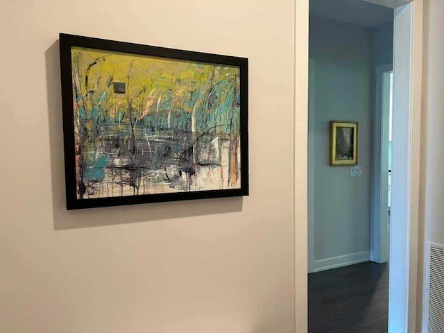 A painting is hanging on a wall in a hallway.