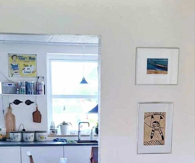 A kitchen with a sign on the wall that says thank you