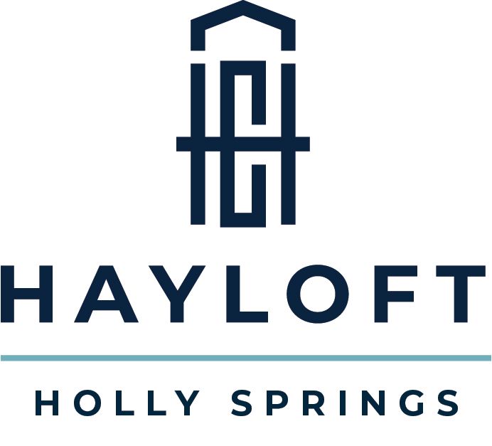 Hayloft Holly Springs logo: a dark blue stylized building over "HAYLOFT," with "HOLLY SPRINGS" below a light blue line.