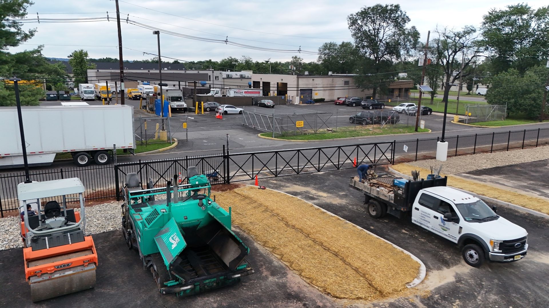 Road construction site with machinery, barriers, and a truck.