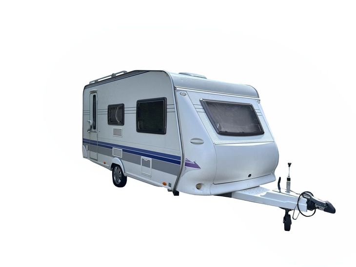 White travel trailer with blue stripes and a front hitch on a plain background