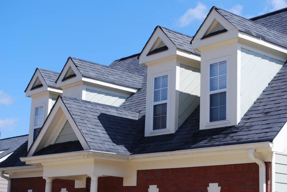 The roof of a house has a lot of windows on it