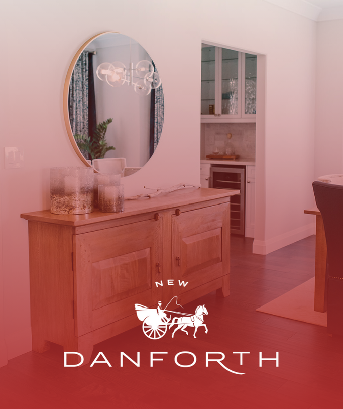 Pink living room with oval mirror, wooden cabinet, and New Danforth logo overlay