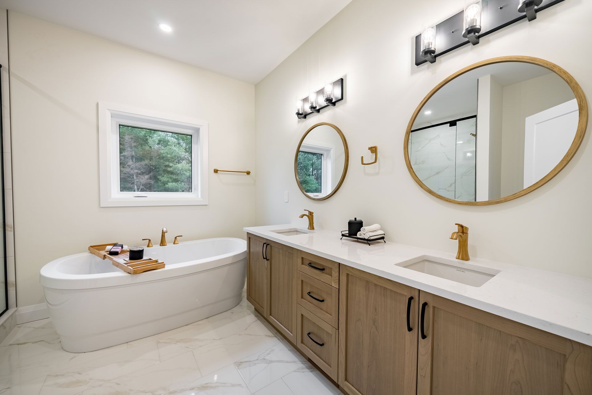 A bathroom with a bathtub and two sinks  in Fidelity Homes Signature build in Cramahe Township