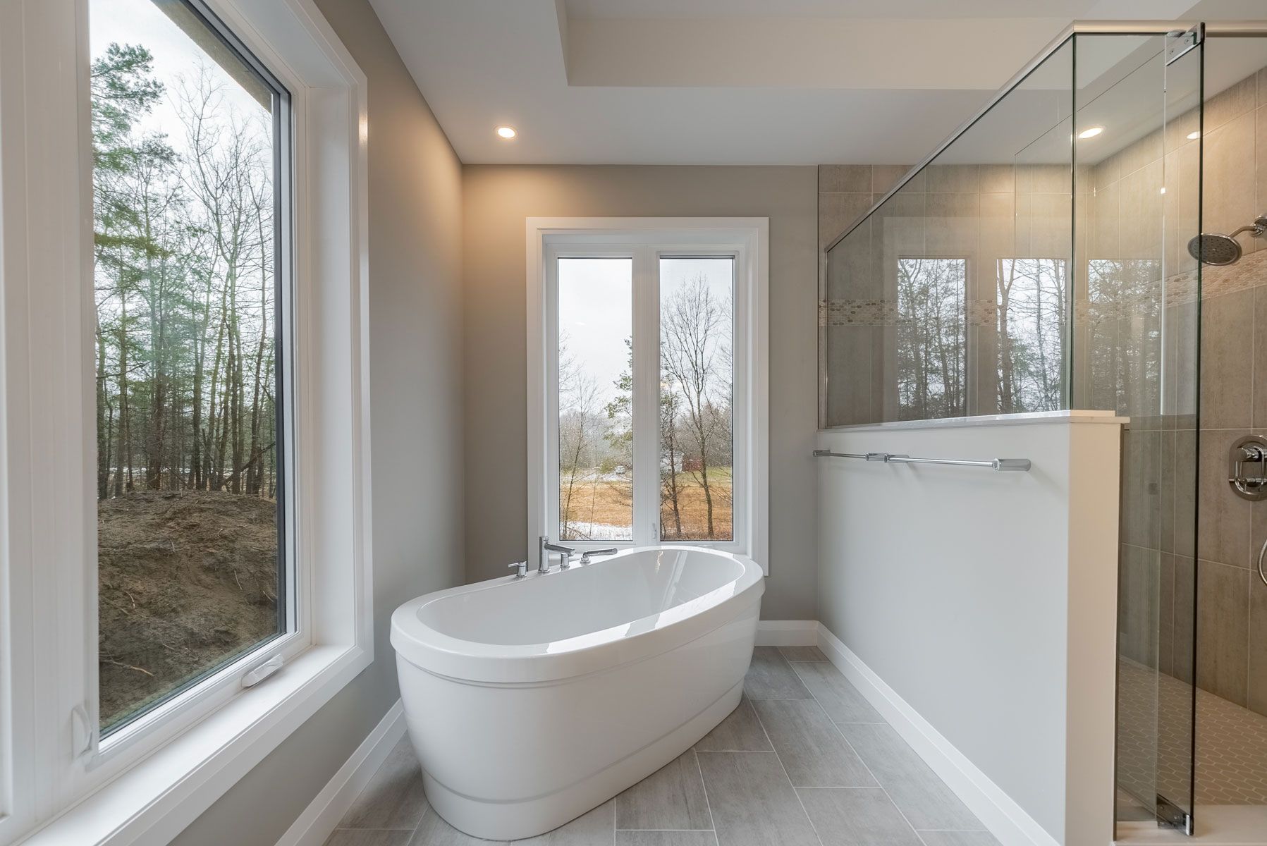 A bathroom with a bathtub and a shower  in Fidelity Homes Signature build in Castleton
