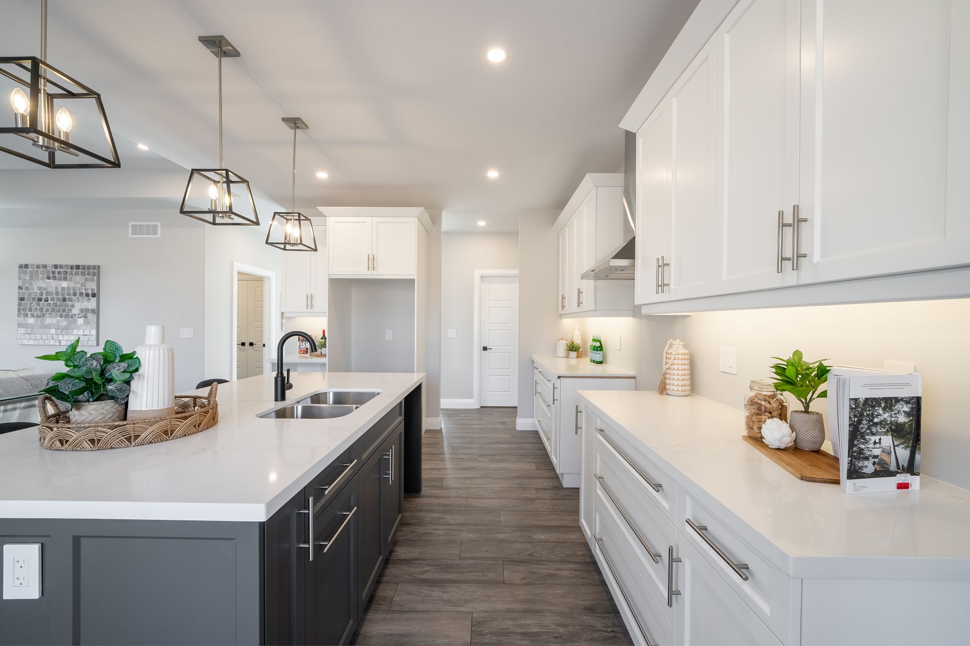 A kitchen with gray cabinets and white counter tops in a Fidelity Homes Signature Build custom home in Colborne Ontario