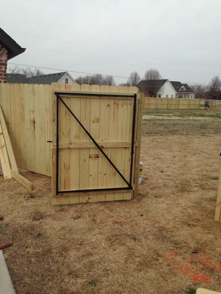 A wooden fence with a gate attached to it
