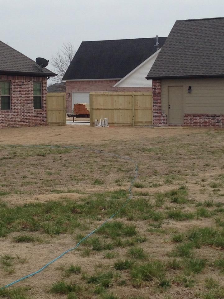 A house with a wooden fence in front of it