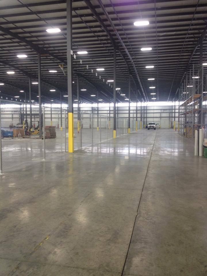 An empty warehouse with a forklift in the background